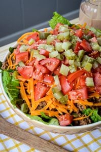 Forget Drive Thru! Try this yummy and healthy Deluxe Cheeseburger Salad! Romaine lettuce is topped with all your favorite Deluxe Cheeseburger toppings for an easy, quick, and healthy meal.